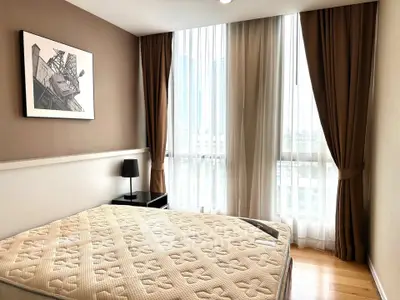 Bright bedroom with large window and modern decor