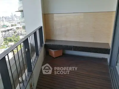 Spacious balcony with city view and wooden flooring in modern apartment