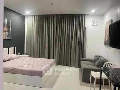 Modern bedroom with stylish decor, featuring a cozy bed, sleek furniture, and elegant curtains.