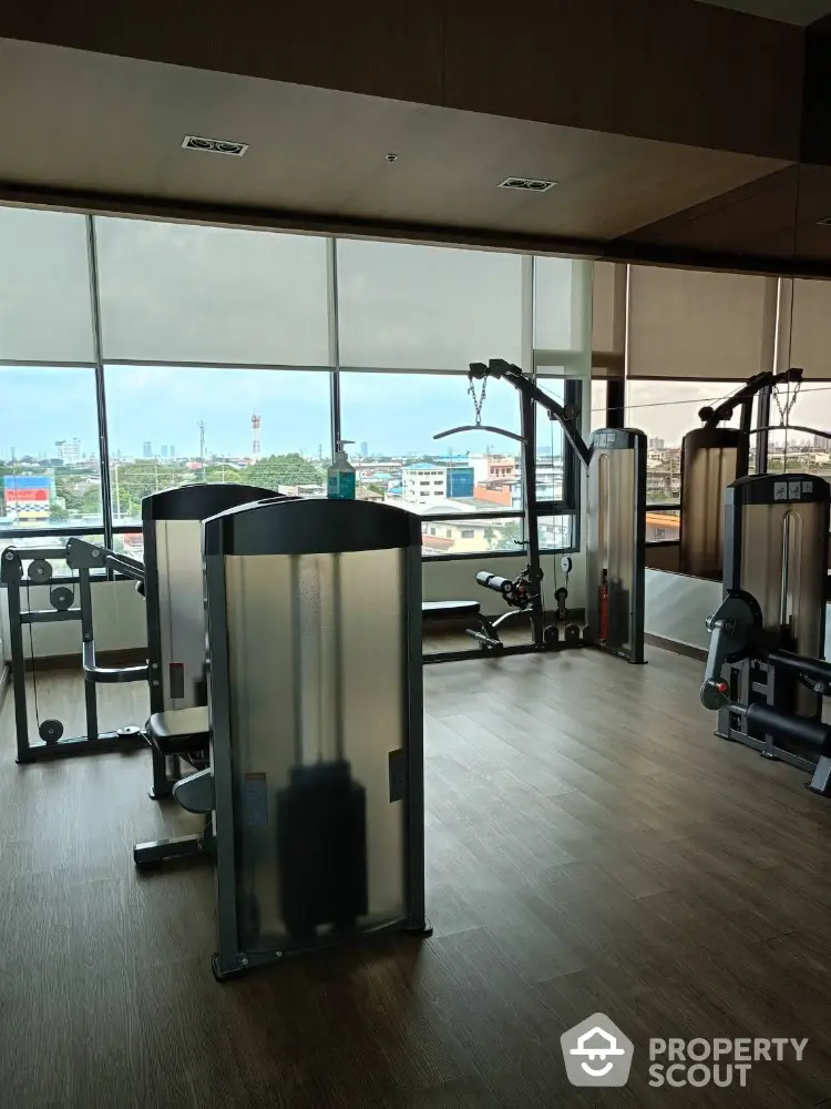 Modern gym with city view and state-of-the-art fitness equipment