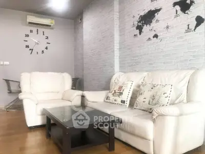 Stylish living room with white leather sofas and world map wall decor