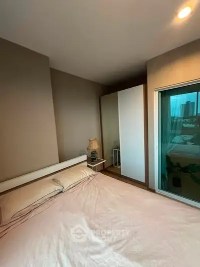 Cozy bedroom with large window and modern decor in urban apartment