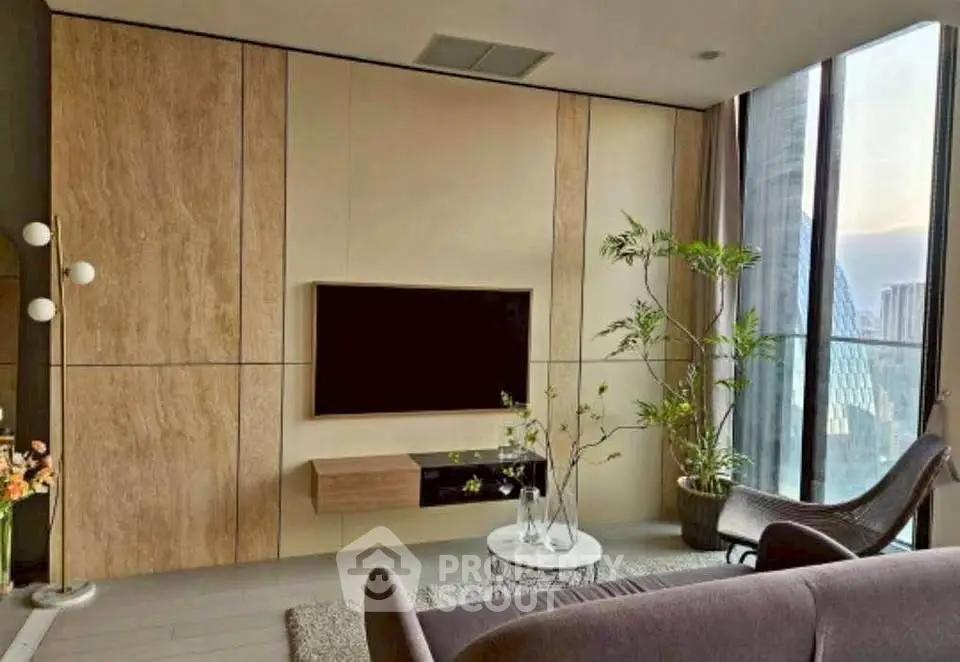 Modern living room with floor-to-ceiling windows and stylish decor in a high-rise apartment.