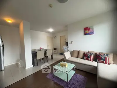 Spacious living room with modern decor and dining area in open layout apartment.