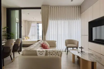 Modern open-plan living room with elegant decor and natural light