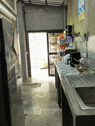 Industrial-style kitchen with concrete countertops and open shelving