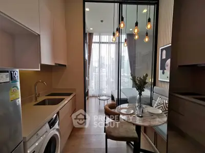Modern apartment with open kitchen and cozy dining area, featuring stylish lighting and city view.