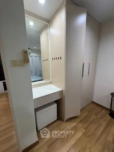 Modern bedroom with built-in wardrobe and wooden flooring