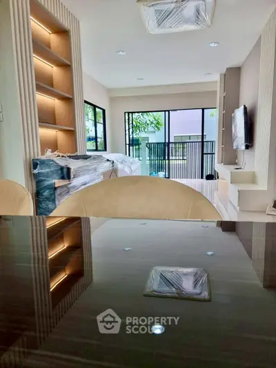 Modern living room with sleek design and large windows for natural light.