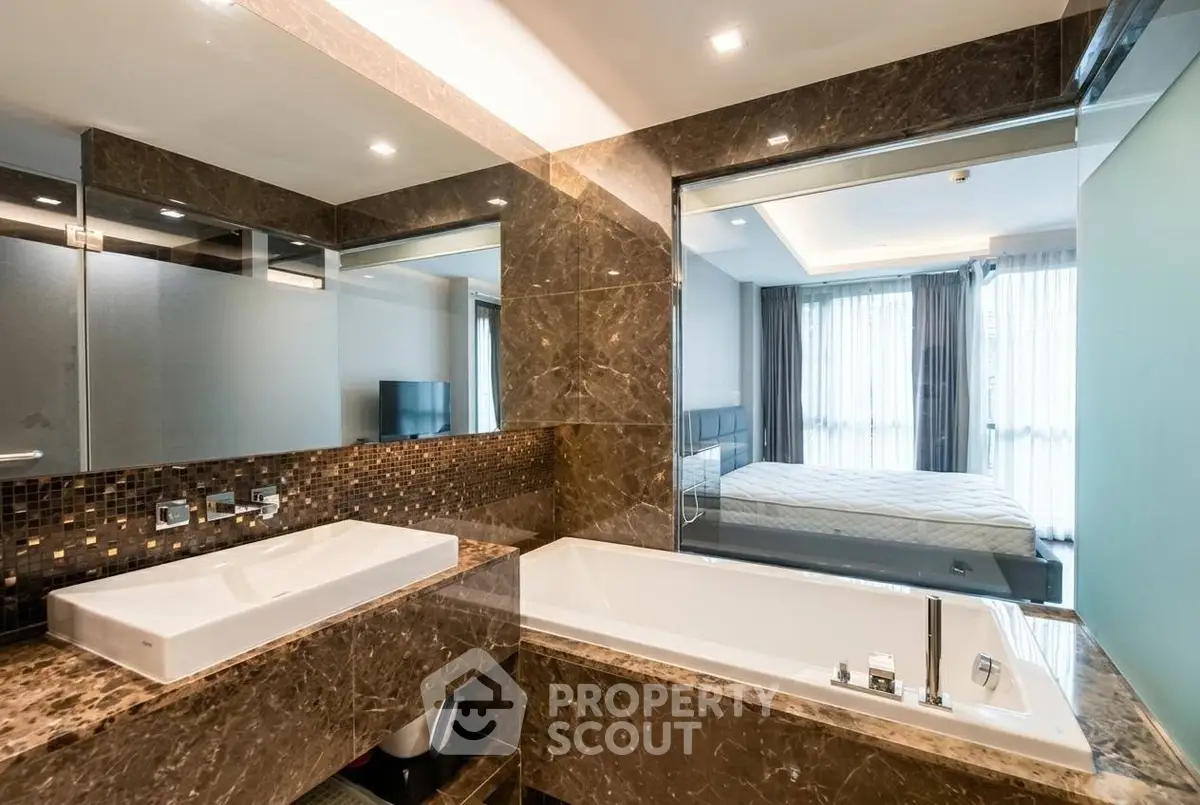 Luxurious bathroom with marble finishes and modern fixtures in a high-end apartment.