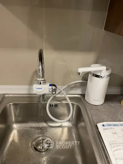 Modern kitchen sink with water filter and dispenser in stylish apartment