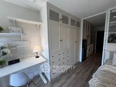 Modern study area with built-in storage and washing machine in compact apartment.