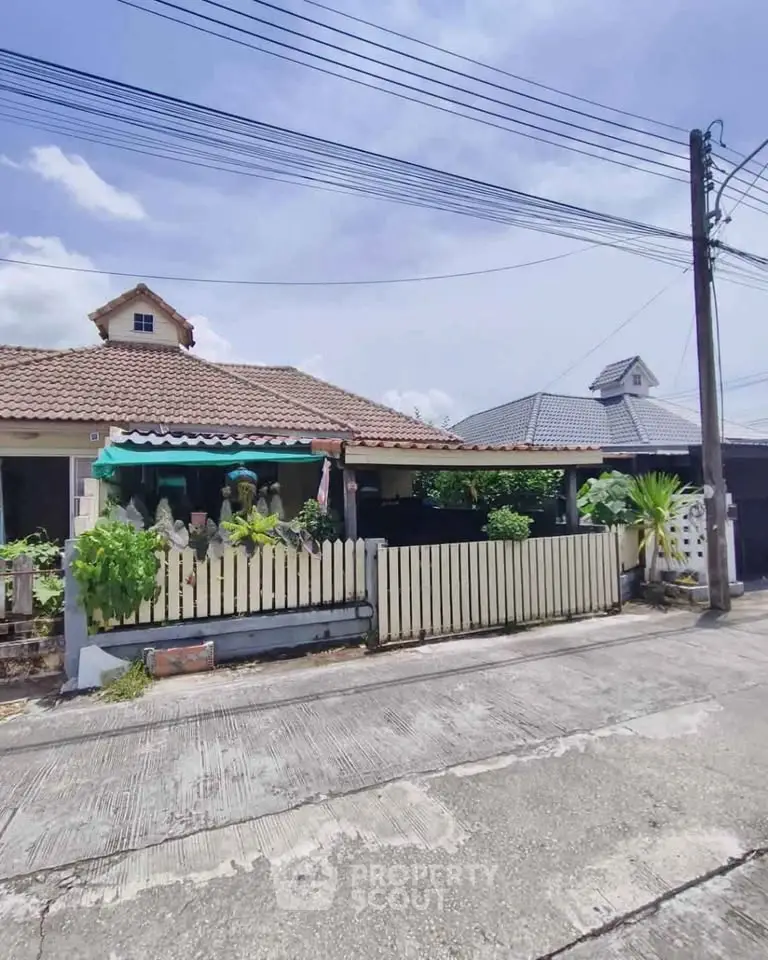 Charming suburban house with a cozy front porch and lush greenery, perfect for family living.