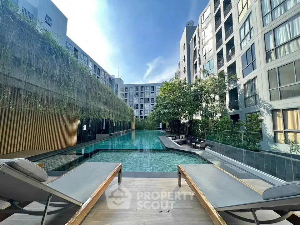Luxurious modern apartment complex with stunning pool and lush greenery