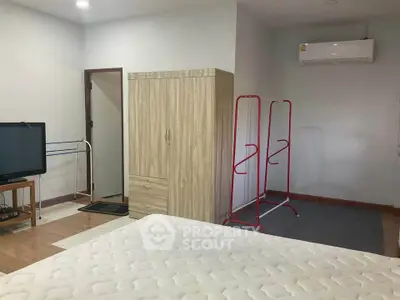 Spacious bedroom with modern amenities and ample storage space