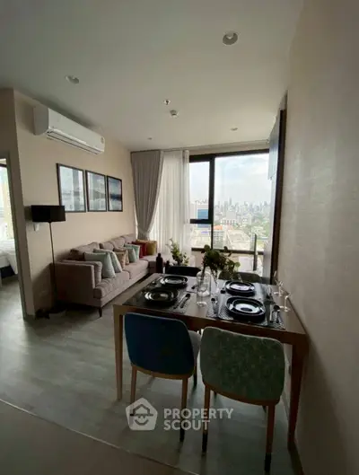 Modern living room with dining area and city view, featuring stylish decor and natural light.