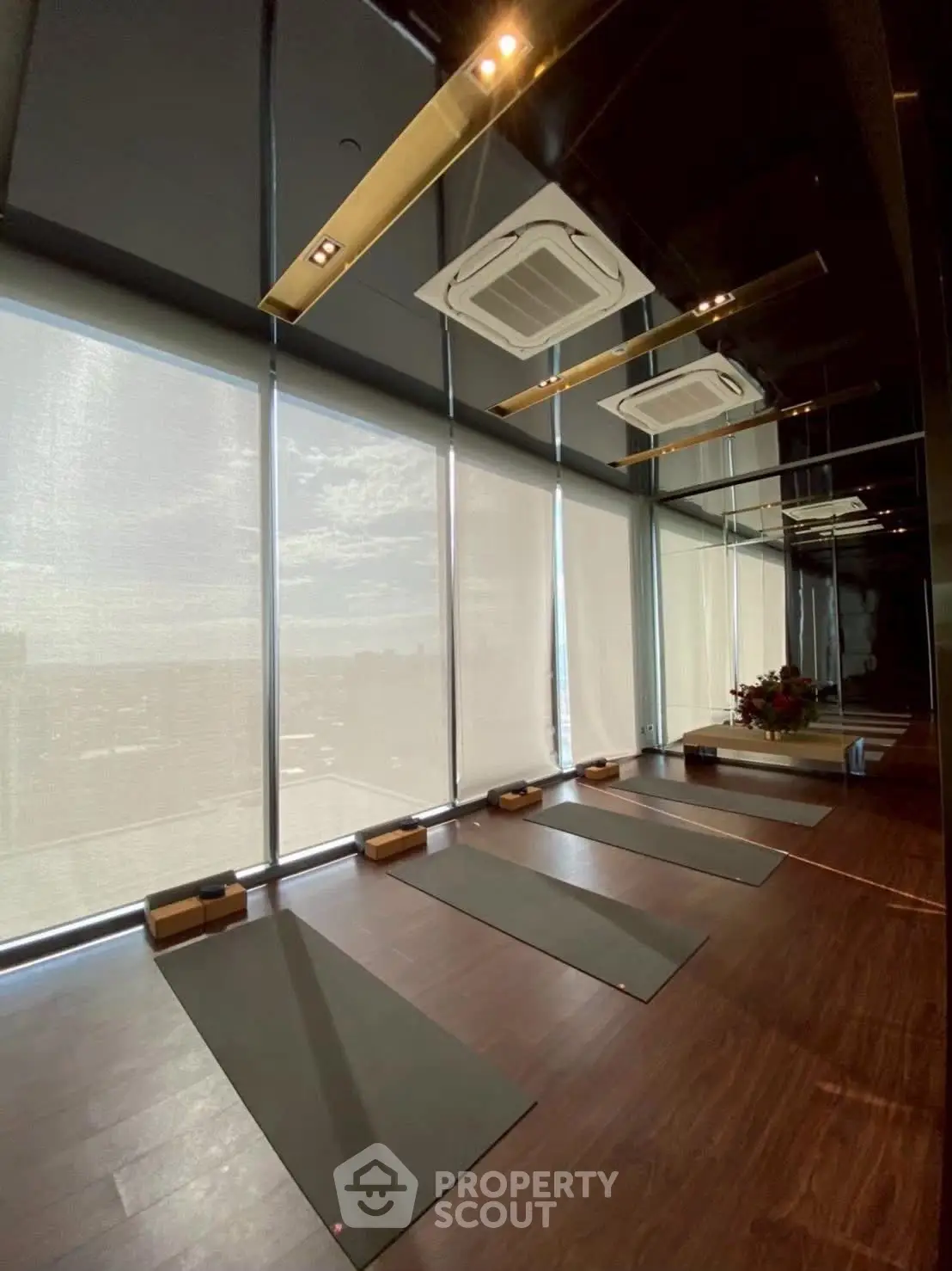 Luxurious yoga studio with floor-to-ceiling windows and modern design