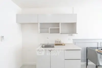 Modern minimalist kitchen with sleek cabinetry and integrated sink