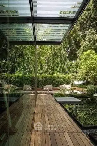 Stunning modern garden with wooden deck and lush greenery, perfect for relaxation and outdoor enjoyment.