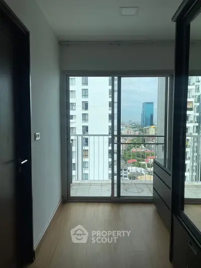 Modern apartment with balcony offering city view and sleek interior design.