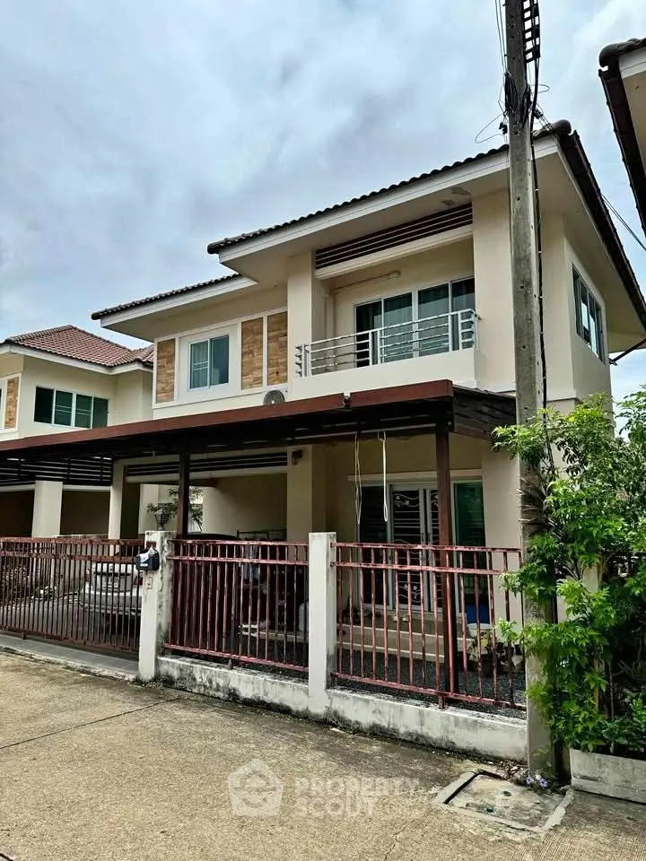Charming two-story house with modern design and spacious balcony in a serene neighborhood.