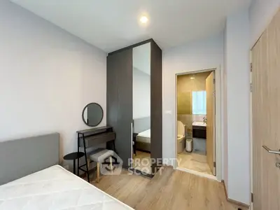 Modern bedroom with ensuite bathroom and stylish furniture