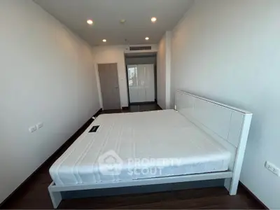 Spacious modern bedroom with sleek design and ample natural light