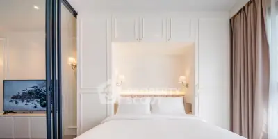 Modern bedroom with elegant white cabinetry and cozy lighting