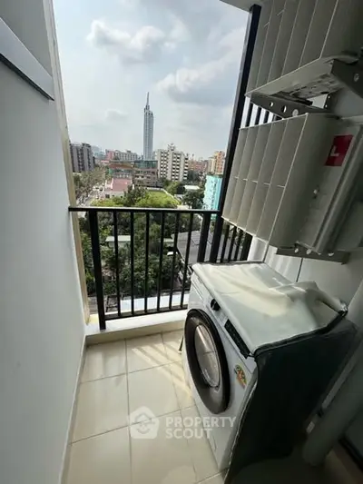 High-rise balcony with city view and washing machine setup.