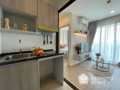 Modern studio apartment with integrated living space, featuring a sleek kitchenette, cozy living area with natural light, and tasteful decor.