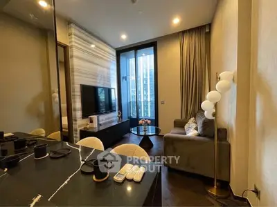 Modern living room with sleek design, featuring a cozy sofa, stylish lighting, and a large window with city view.