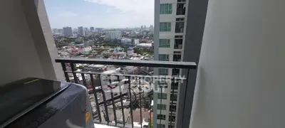 High-rise balcony with cityscape view and washing machine, perfect for urban living.