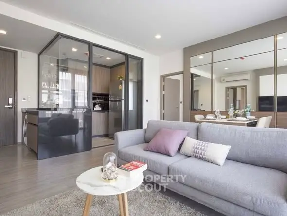 Modern living room with open kitchen and stylish decor in a contemporary apartment.