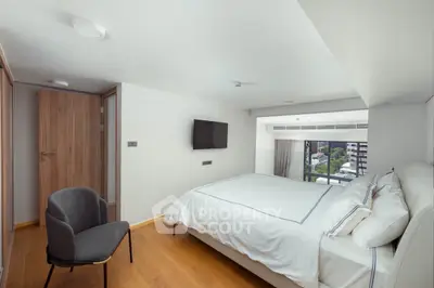 Modern bedroom with large window and stylish decor in urban apartment