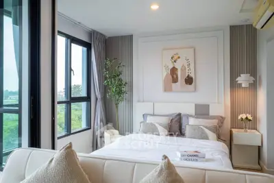 Modern bedroom with large windows and stylish decor in a high-rise apartment.