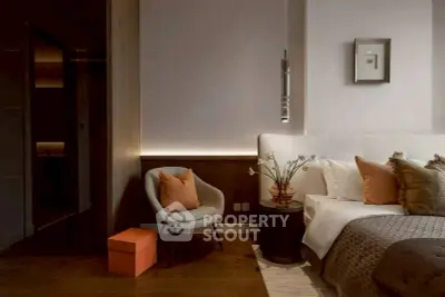 Luxurious modern bedroom with elegant decor and cozy seating area.