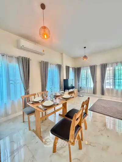 Spacious living room with dining area, modern decor, and ample natural light.