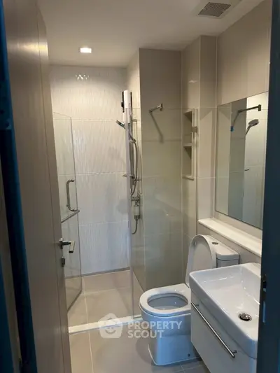 Modern bathroom with glass shower and sleek fixtures