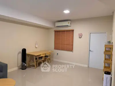 Spacious living room with modern furniture and air conditioning, perfect for comfortable living.