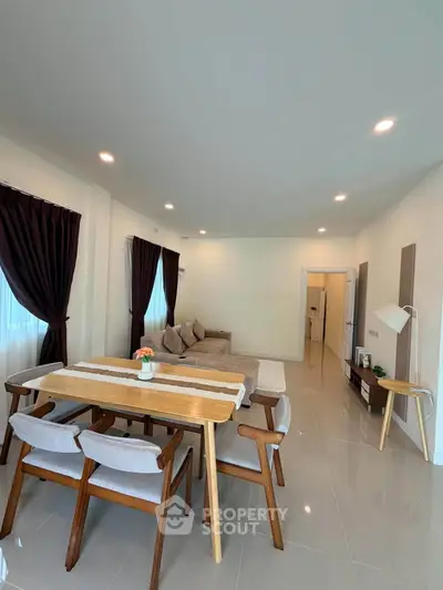 Spacious modern living room with elegant dining area and cozy seating.