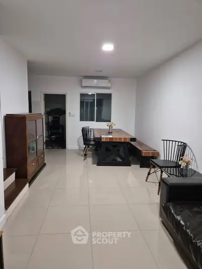 Modern living room with sleek furniture and polished tile flooring