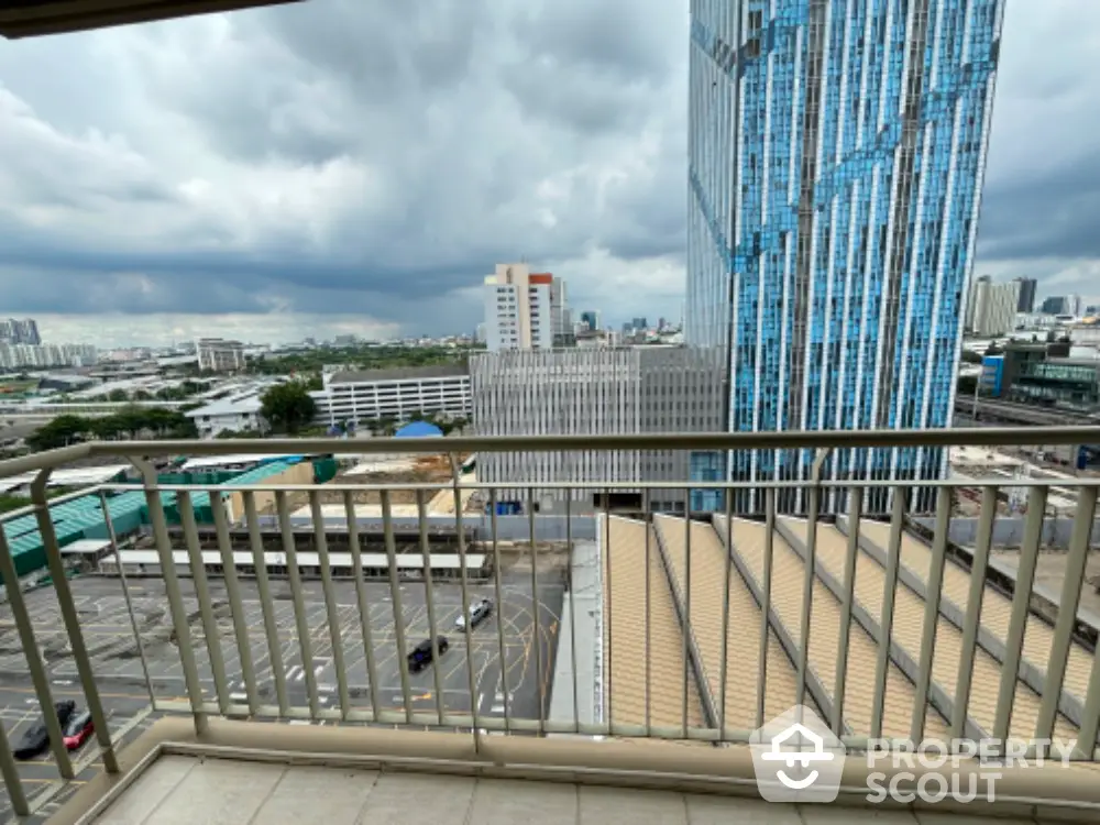 Stunning cityscape view from a modern balcony overlooking skyscrapers and urban landscape.