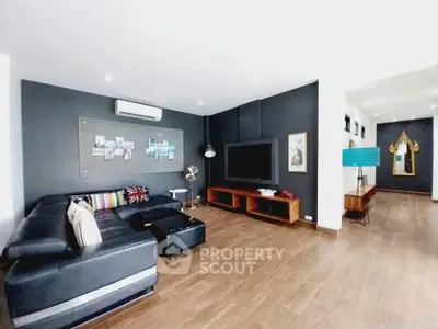 Spacious modern living room with dark accent wall and stylish decor