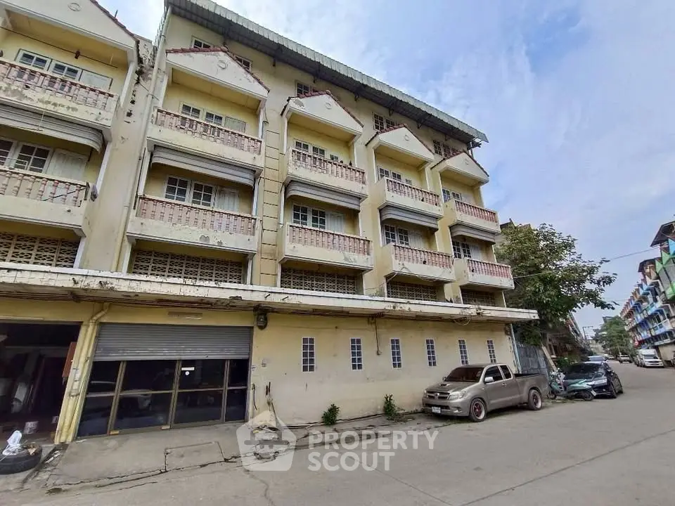 Charming multi-story building with classic balconies and street view, ideal for urban living or investment.