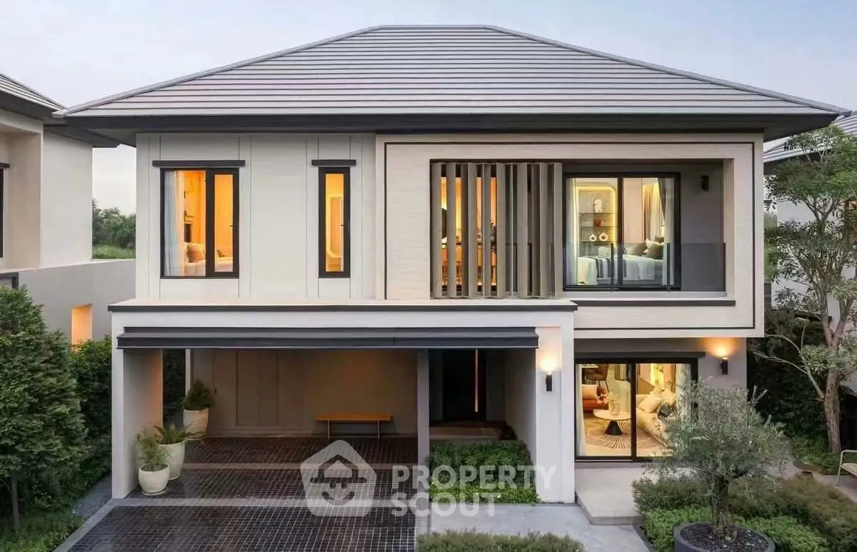 Modern two-story house with sleek design and spacious driveway in a serene neighborhood.