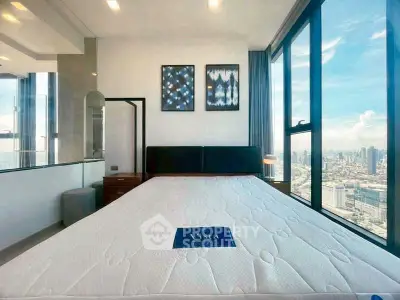 Luxurious bedroom with stunning city view and modern decor in high-rise apartment.