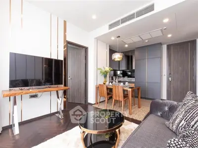 Modern living room with stylish furniture and open kitchen layout in luxury apartment.