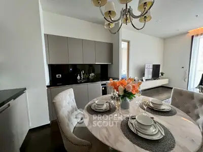 Elegant dining area with modern kitchen and stylish decor in a luxurious apartment.