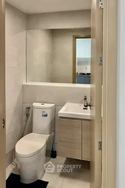 Modern bathroom with sleek fixtures and neutral tones, perfect for a contemporary home.