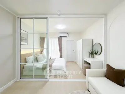 Modern bedroom with sliding glass doors and stylish decor in a bright apartment.